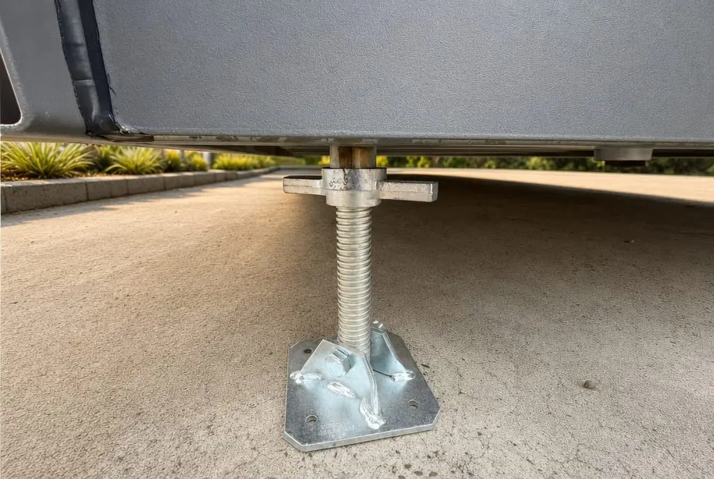 The adjustable galvanised steel footing a MicroHome sits on, levelled on a prepared pad.