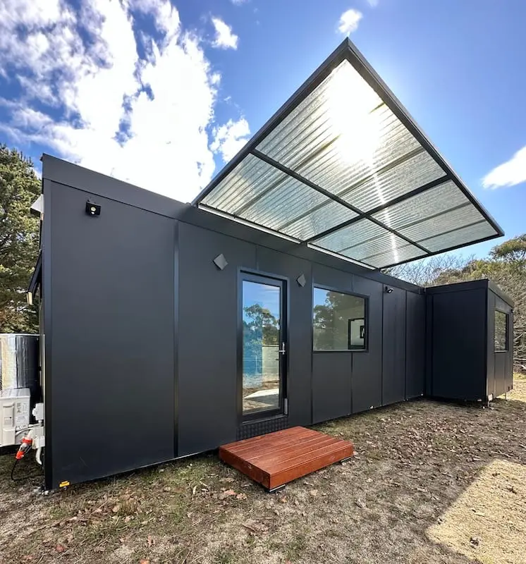 An Urban Modular on a rural block — two modules joined under a steel awning.