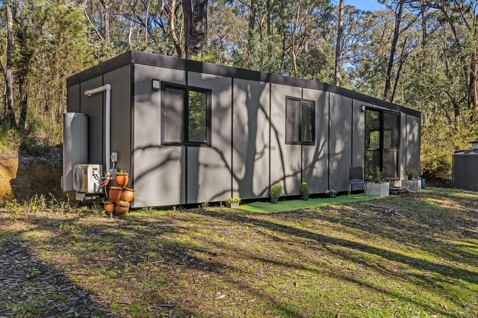 A finished Urban One Bedroom MicroHome sited and levelled on a cleared bush block.
