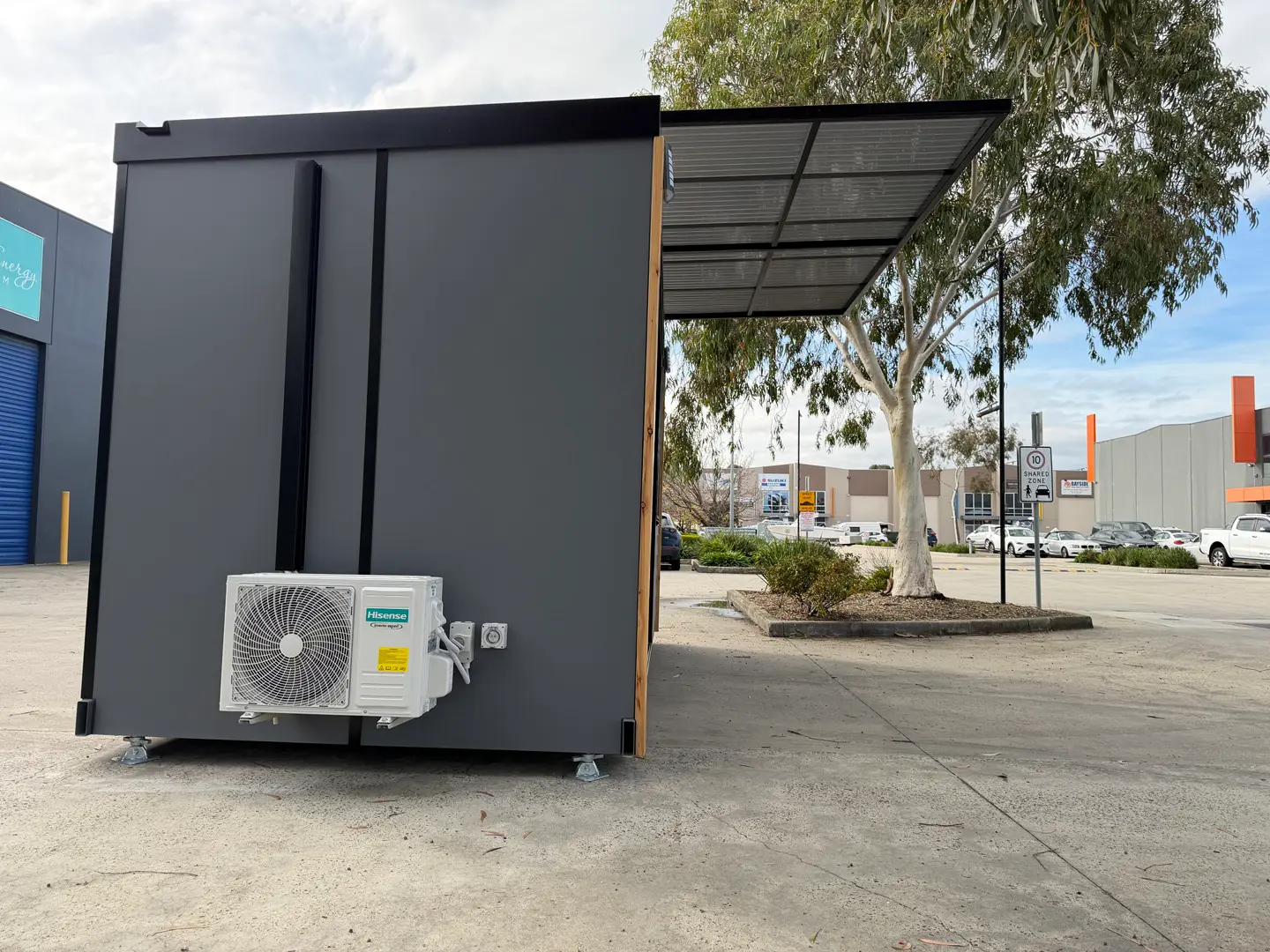 The utility end of the ex-demo Backyard Pod, with the outdoor air-conditioning unit mounted on the wall.