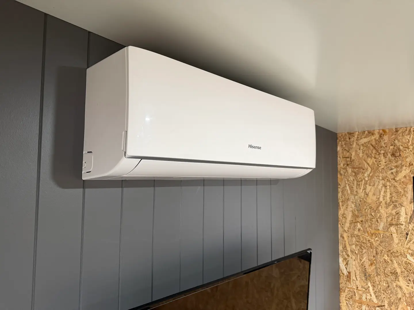 The split-system heating and cooling unit mounted high on the wall of the ex-demo Backyard Pod.