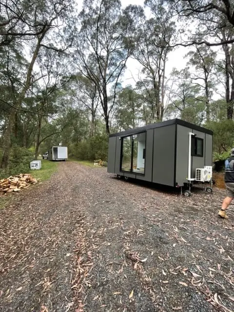 A MicroHome at the end of a gravel drive in bushland, ready to move into.