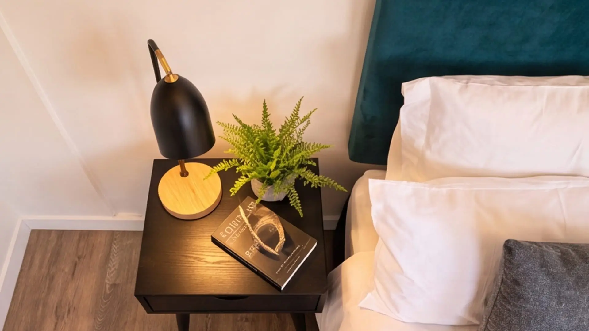Bedside detail inside the Urban Studio — lamp, styling and linen.