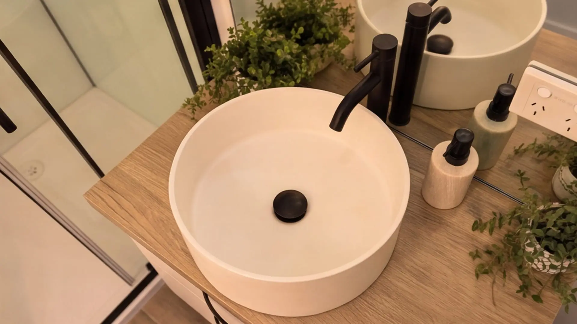Bathroom vanity with vessel basin and timber benchtop inside the Urban Studio.